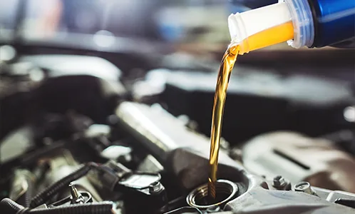 Engine oil being poured into a car engine